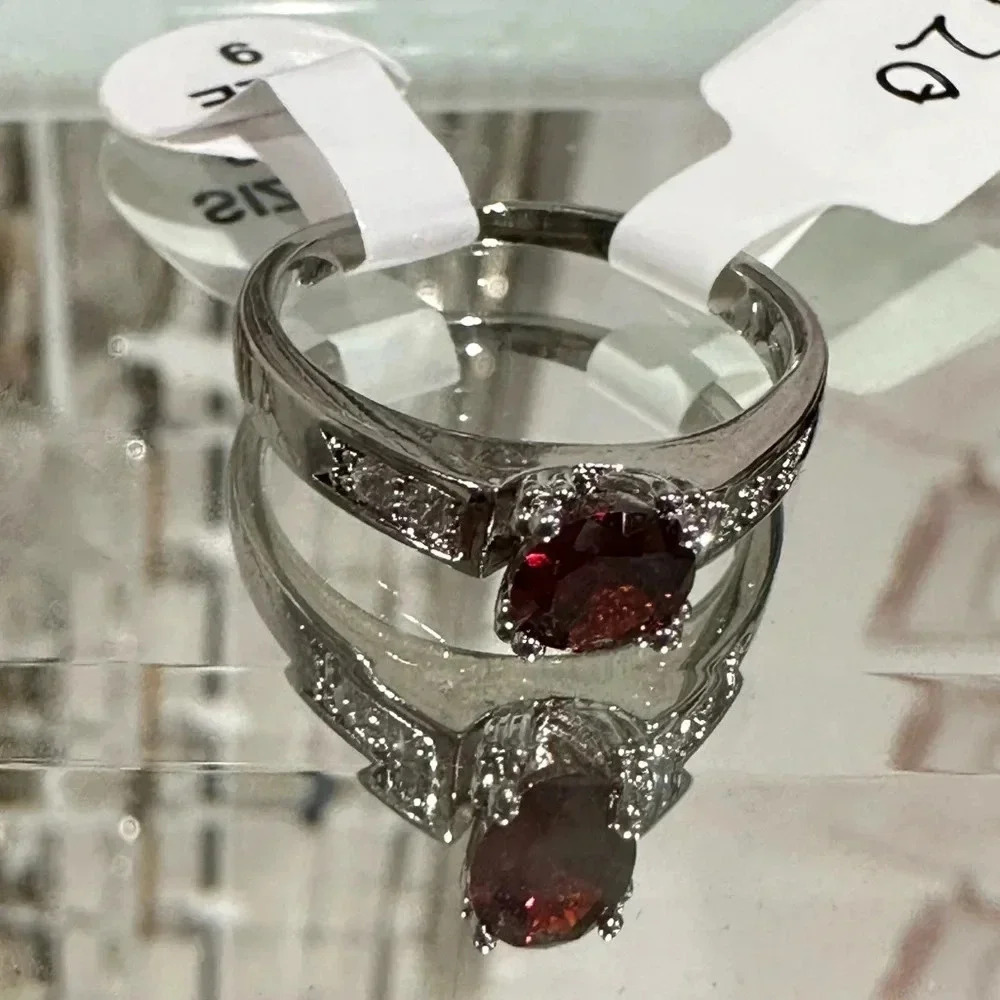 Beautiful new Size 9 ring. Silver rhinestone band with red stone women’s jewelry